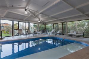 a swimming pool in a house with glass windows at Koanze Luxury Hotel & Spa in Atemajac de Brizuela