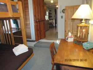 a room with a dining table and a bunk bed at Apple Bear Cabin in Big Bear City