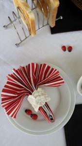 a white table topped with a red and white cake at Villa Xanelle Boutique Guest House in Centurion