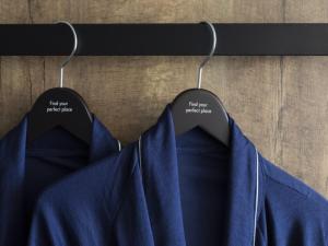 a couple of hangers with blue shirts on them at THE KNOT TOKYO Shinjuku in Tokyo