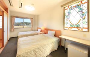 מיטה או מיטות בחדר ב-Hotel Bouenkaku