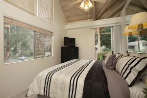 a bedroom with a bed and a large window at Mountain Cove Private Condo in Indian Wells