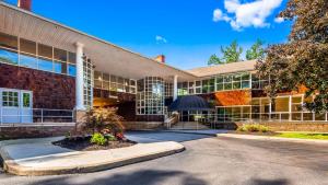 a large brick building with a lot of windows at Best Western Plus The Inn & Suites at the Falls in Poughkeepsie