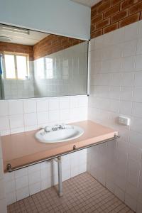 La salle de bains est pourvue d'un lavabo et d'un miroir. dans l'établissement Gascoyne Hotel, à Carnarvon