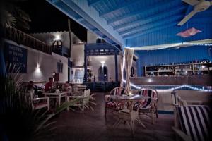 a restaurant with tables and chairs and people sitting in it at El Primo Hotel Dahab in Dahab