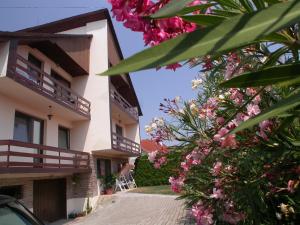 a building with pink flowers in front of it at Heviz Therme Apartmenthaus in Hévíz