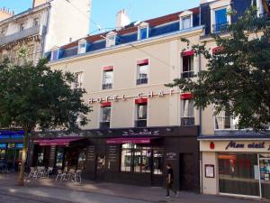 a person walking in front of a building at Hôtel Chateaubriand in Dijon