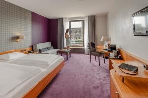 Postel nebo postele na pokoji v ubytování Mercure Hotel Trier Porta Nigra