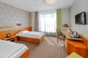 Postel nebo postele na pokoji v ubytování Mercure Hotel Trier Porta Nigra