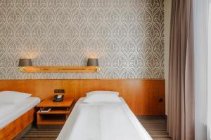 Postel nebo postele na pokoji v ubytování Mercure Hotel Trier Porta Nigra