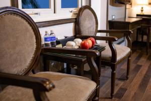 a tray with apples and bottles of water on a table at Alisa Hotel & Spa in Hanoi +72 photos