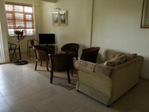 a living room with a couch and chairs at Trendzone Apartments in Grand Baie