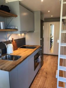 a kitchen with a sink and a wooden floor at Lakeview Studio in Stavsjo