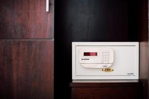 a microwave oven sitting on top of a wooden cabinet at Harvest House in Ao Nang Beach