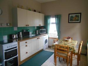 a kitchen with a table and a table and a dining room at Belvedere Holiday Home in Whitehills