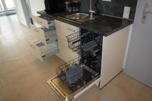 a kitchen with a counter with dish drying racks at Appartement mit Aussicht in Mülheim an der Ruhr