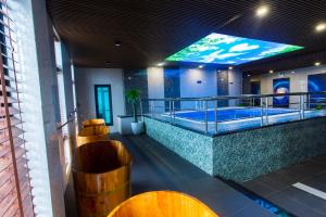 a hotel lobby with a hot tub on a balcony at Eagle Hotel in Hà Tĩnh