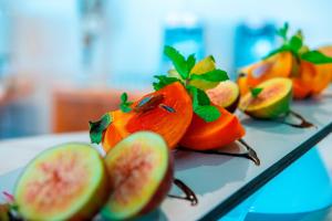 a bunch of fruit on a table with apples at Queens Bay Hotel in Paphos