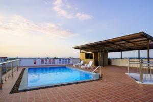 a swimming pool on the roof of a building at Intouch Riverside Hotel in Pakse