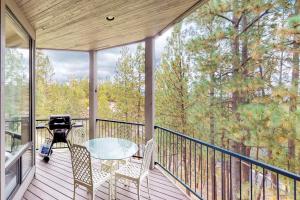 a screened in porch with a table and chairs on it at Ponderosa Views in Bend