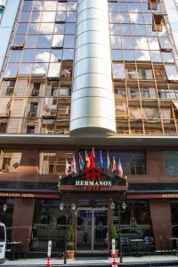 a hotel with flags on the front of a building at Hermanos Hotel in Istanbul