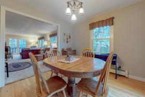 a dining room with a wooden table and chairs at Hummingbird Hideout in Estes Park