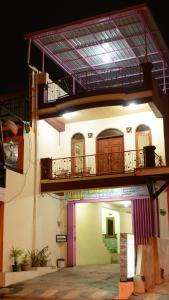 a building with a balcony on the side of it at Villa Amanah in Batu