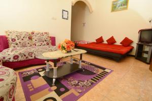 a living room with a couch and a table at Villa Amanah in Batu