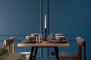 a dining room table with a candle on it at Elite Apartments Oliwa Martinique in Gdańsk