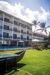 a hotel with a boat in front of it at Serendib Beach Hotel in Bentota