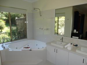 a white bathroom with a tub and a sink at Pinda Lodge in Margaret River Town