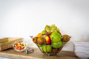 a basket of fruits and vegetables on a counter at Adams Hotel in Metz