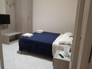 a bedroom with a bed with a blue comforter at chicchinella in Altamura