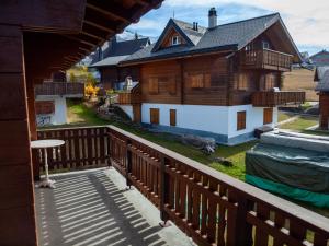 a view of a house from a balcony at Chalet Bärgsunna in Rosswald