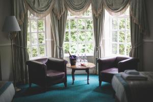a living room filled with furniture and a window at Mere Court Hotel in Knutsford