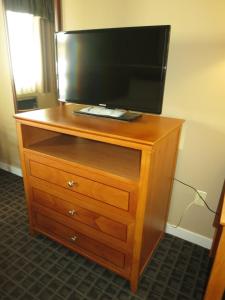 
a wooden desk with a television on top of it at SureStay Hotel by Best Western North Vancouver Capilano in North Vancouver
