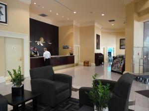 a lobby of a hospital with two people standing at a counter at Rosedale on Robson Suite Hotel in Vancouver +37 photos