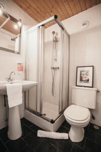 a bathroom with a shower and a toilet and a sink at La Taverne in Méribel +37 photos
