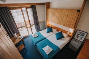 Postel nebo postele na pokoji v ubytování La Taverne