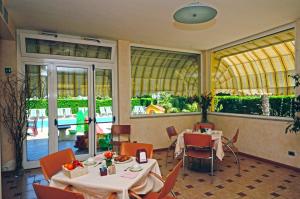 a restaurant with two tables and chairs and a balcony at Residence Villa Gloria in Borgio Verezzi