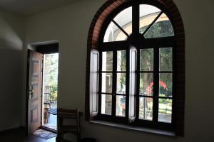 an arched window in a room with a door at Passaggio a Nord Ovest in Settimo Vittone