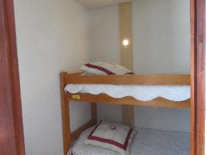 a small room with two bunk beds in it at LE Hameau 001 in Manigod