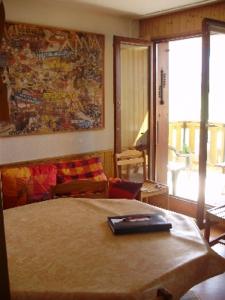 a bedroom with a bed and a large window at MONT BLANC Soleil C19 in Manigod
