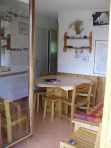 a kitchen with a table and chairs in a room at MONT BLANC Soleil C19 in Manigod