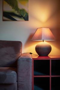 a lamp sitting on a table next to a couch at Apartamentos Turisticos Atlantida in Funchal