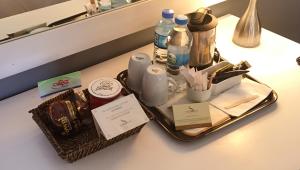 a tray with bottles and other items on a counter at Surmeli Istanbul Hotel in Istanbul