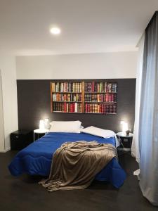 a bedroom with a bed and a book shelf with books at Hotel Panorama in Chianciano Terme