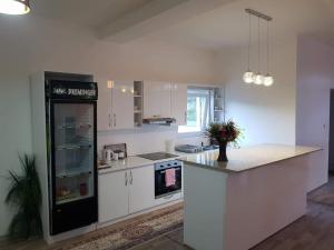 a kitchen with white cabinets and a black refrigerator at Vinac guest house in Jajce