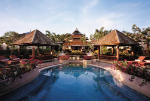 a pool at a resort with two gazebos at Shangri-La Mactan, Cebu in Mactan