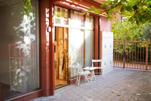 a porch with glass doors and a chair on a patio at 4 Seasons apartments, A1 in Plovdiv